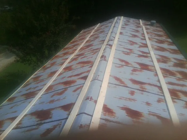 Rusted metal roof panels with new wood purlins before replacement — Storm Damage Roof Repair in Bedrock by Roofing Brothers