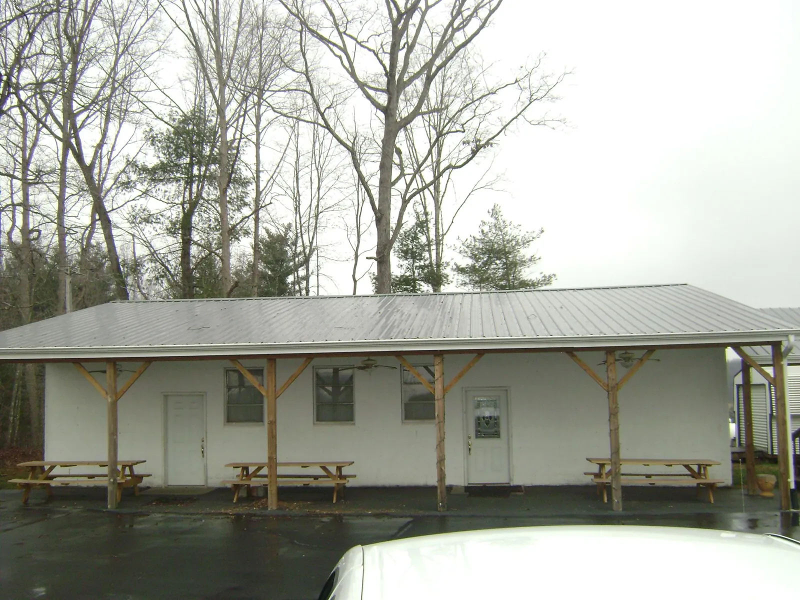 Gray metal roof over a block building with a timber post porch in Bedrock
